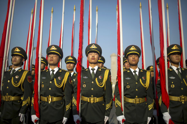 Flagbearers of a Chinese honor guard stand in formation before a welcome ceremony for Argentina's President Mauricio Macri at the Great Hall of the People in Beijing, Wednesday, May 17, 2017. (Photo by Mark Schiefelbein/AP Photo)