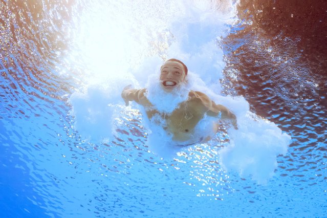 An underwater view shows Britain's Jordan Christopher Houlden competing in the men's 3m springboard diving preliminary during the Paris 2024 Olympic Games at the Aquatics Centre in Saint-Denis, north of Paris, on August 6, 2024. (Photo by Oli Scarff/AFP Photo)