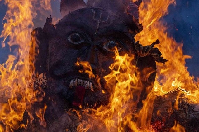 People burn an effigy of demon Ghantakarna to represent the demolition of evil during the Ghantakarna festival in Bhaktapur, Nepal, Friday, August 2, 2024. (Photo by Niranjan Shrestha/AP Photo)