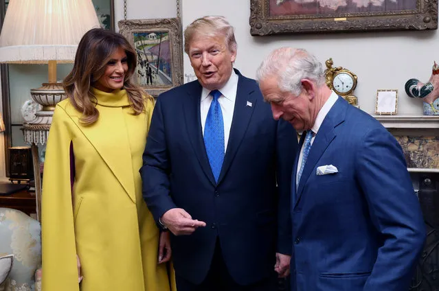 Britain's Prince Charles, Prince of Wales (R), US President Donald Trump (C) and US First Lady Melania Trump (L) talk as they pose for photographs at Clarence House in central London on December 3, 2019, ahead of the NATO alliance summit. NATO leaders gather Tuesday for a summit to mark the alliance's 70th anniversary but with leaders feuding and name-calling over money and strategy, the mood is far from festive. (Photo by Chris Jackson/Pool/AFP Photo)