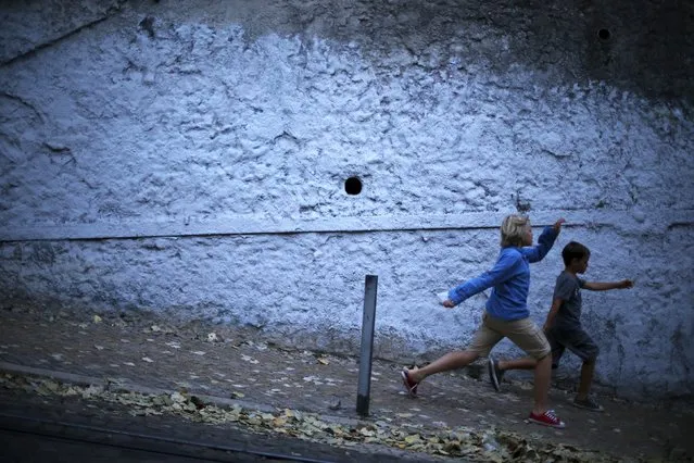 Children joke as they walk down a slope in downtown Lisbon, Portugal July 30, 2015. (Photo by Rafael Marchante/Reuters)