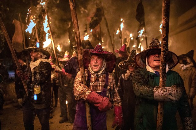 People walk with torches in the celebration of the Civic Procession of Vitor, on 27 September, 2021 in Mayorga, Valladolid, Castilla y Leon, Spain. After two years without being able to carry out this procession due to the coronavirus crisis, this September 27 the Valladolid town of Mayorga celebrates its traditional parade in which the villagers walk with torches, made with grape skins, from the house of Santo Toribio de Mogroviejo to the hermitage. The burning of the skins, an act programmed as part of the patron saint's festivities, commemorates the arrival of the relics of the Saint to his birthplace. During the parade, songs and fireworks enliven the walk to conclude the celebration in the local peñas. (Photo By Emilio Fraile/Europa Press via Getty Images)