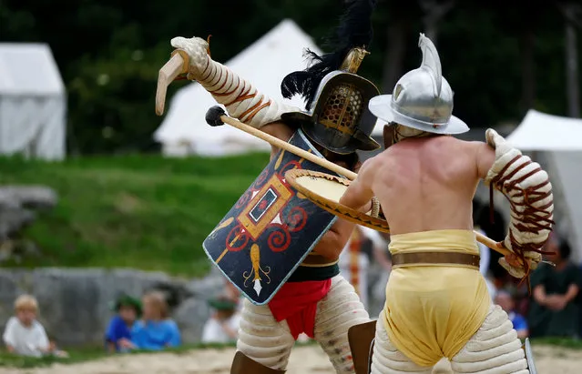 Members of the “Familia Gladiatoria Carnuntina” fight in the historic amphitheatre during the Roman Festival at the archeological site of Carnuntum in Petronell, Austria, June 11, 2016. (Photo by Leonhard Foeger/Reuters)