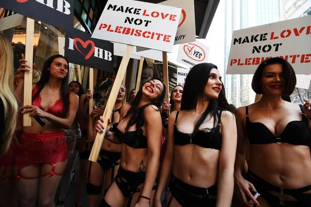 Models in lingerie are seen walking the streets of Sydney during a marketing campaign in support of marriage equality in Sydney, Australia on August 14, 2017. On Monday, 60 Honey Birdette employees took to the streets of the Sydney CBD in support for marriage equality ahead of the federal government’s controversial postal plebiscite on the topic, with forms slated to arrive in Australians’ mailboxes on September 12. (Photo by PA Wire)