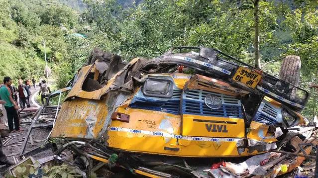 This photograph provided by Deputy Commissioner's office, Kullu, shows the wreckage of a passenger that bus slid off a mountain road and fell into a deep gorge near Kullu, Himachal Pradesh state, India, Monday, July 4, 2022. More than a dozen people including schoolchildren were killed in the accident. (Photo by Deputy Commissioner's office, Kullu via AP Photo)