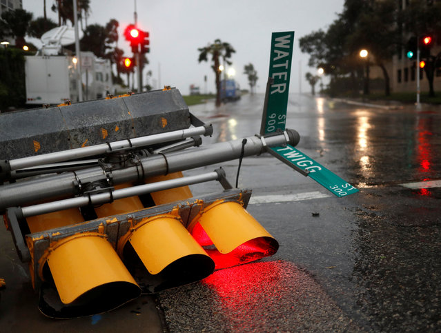 Traffic lights lie on a street after being knocked down, as Hurricane Harvey approaches in Corpus Christi, Texas on August 26, 2017. (Photo by Adrees Latif/Reuters)