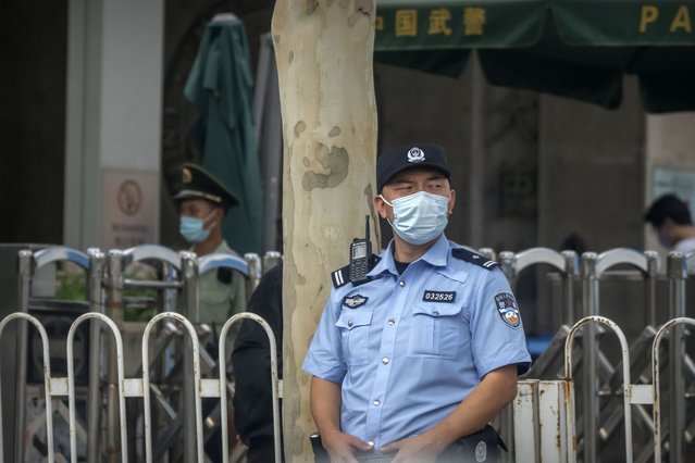A police officer stands guard outside the U.S. Embassy in Beijing, Wednesday, August 3, 2022. U.S. House Speaker Nancy Pelosi arrived in Taiwan late Tuesday, becoming the highest-ranking American official in 25 years to visit the self-ruled island claimed by China, which quickly announced that it would conduct military maneuvers in retaliation for her presence. (Photo by Mark Schiefelbein/AP Photo)