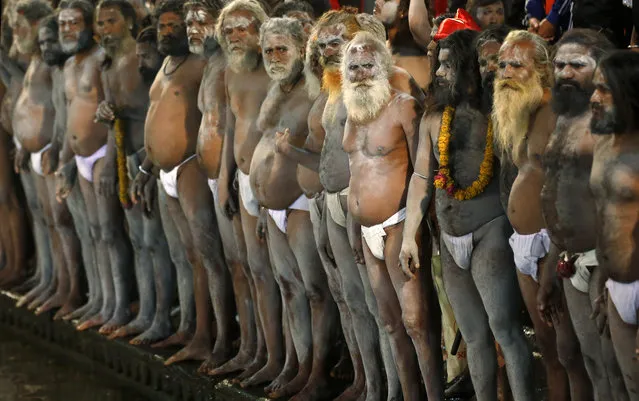 Naked Hindu holy men wait to bath in the Godavari River during Kumbh Mela, or Pitcher Festival, at Trimbakeshwar in Nasik, India, Saturday, August 29, 2015. (Photo by Rajanish Kakade/AP Photo)