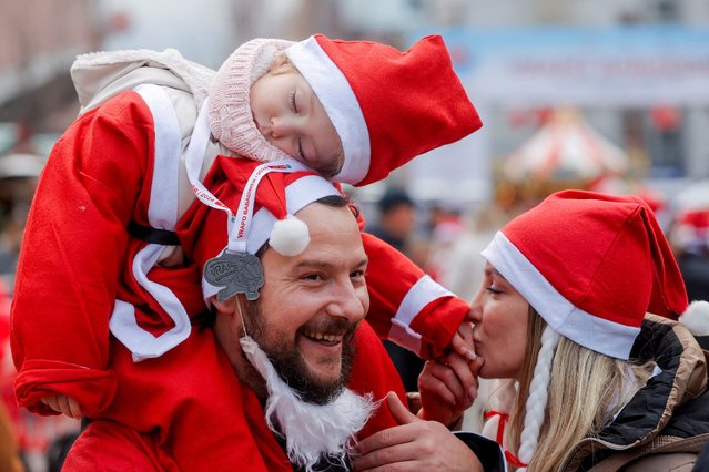 Participants wearing Santa Claus-themed outfits take part in a charity run, in Pristina, Kosovo on December 15, 2024. (Photo by Valdrin Xhemaj/Reuters)