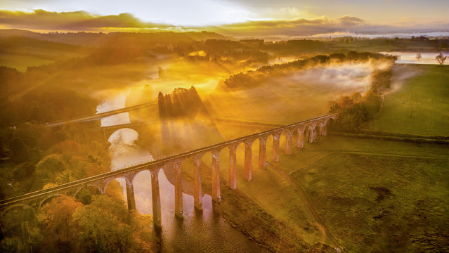 The sun rises over the misty landscape above the River Tweed, with a view of the three bridges that span the river that winds its way through the South of Scotland on November 7, 2024. (Photo by Phil Wilkinson)