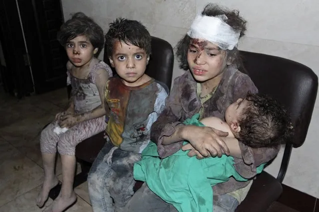 Injured children rest in a field hospital, after what activists claim were two air strikes by forces loyal to Syria's President Bashar al-Assad, in Douma, eastern al-Ghouta, near Damascus September 14, 2014. (Photo by Badra Mamet/Reuters)