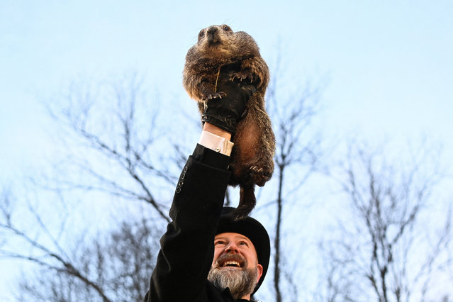 AJ Dereume holds up groundhog Punxsutawney Phil, as he makes his prediction on how long winter will last, during the Groundhog Day festivities, at Gobbler's Knob in Punxsutawney, Pennsylvania on February 2, 2025. (Photo by Alan Freed/Reuters)