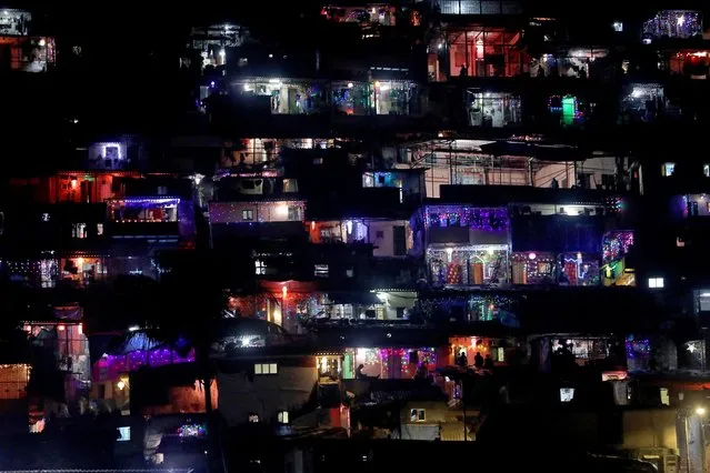 Houses are lit up with decorative lights and lanterns on the occasion of Diwali, the Hindu festival of lights, at a slum in Mumbai, India on October 24, 2022. (Photo by Niharika Kulkarni/Reuters)