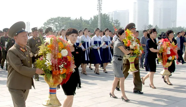Floral baskets are placed before the statues of founder Kim Il Sung and late leader Kim Jong Il on Mansu Hill Thursday on the 22nd anniversary of demise of Kim Il Sung in this photo released by North Korea's Korean Central News Agency (KCNA) on July 8, 2016. (Photo by Reuters/KCNA)