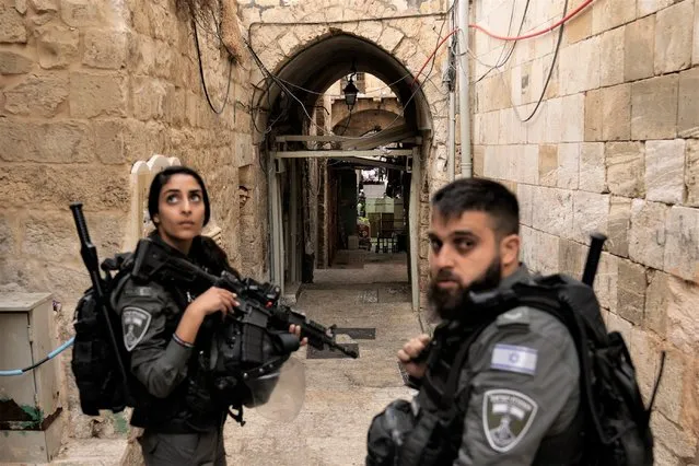 Israeli border police officers stand guard next to the scene of a stabbing attack in Jerusalem's Old City, Thursday, November 3, 2022. A Palestinian stabbed a police officer lightly wounding him, and officers opened fire on the attacker, killing him, Israeli police said. (Photo by Mahmoud Illean/AP Photo)