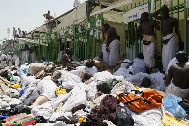 Muslim pilgrims gather around bodies of people crushed in Mina, Saudi Arabia during the annual hajj pilgrimage on Thursday, September 24, 2015. Hundreds were killed and injured, Saudi authorities said. The crush happened in Mina, a large valley about five kilometers (three miles) from the holy city of Mecca that has been the site of hajj stampedes in years past. (Photo by AP Photo)