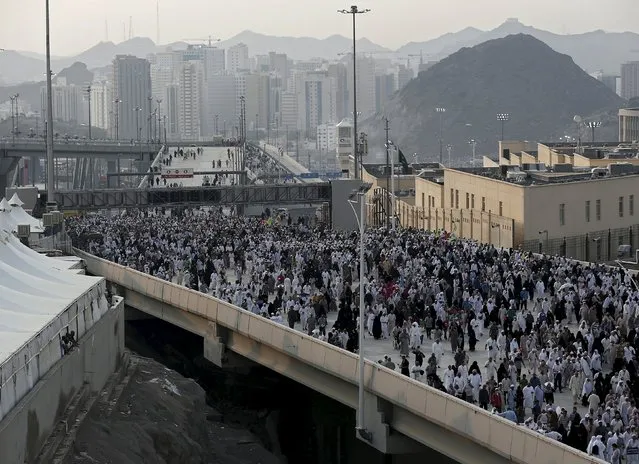 Muslim pilgrims walks on a bridge as they head to cast stones at pillars symbolizing Satan during the annual haj pilgrimage in Mina, on the second day of Eid al-Adha, near the holy city of Mecca September 25, 2015. (Photo by Ahmad Masood/Reuters)