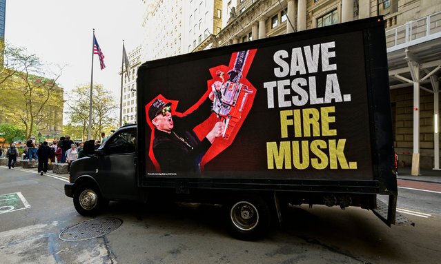 A truck with signage reading “Save Tesla. Fire Musk” drives around Manhattan on April 22, 2025 in New York City. (Photo by Eugene Gologursky/Getty Images for Save Tesla Fire Musk Campaign)