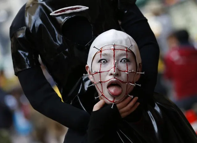 A participant in costume poses for a picture before a Halloween parade in Kawasaki, south of Tokyo, October 26, 2014. (Photo by Yuya Shino/Reuters)