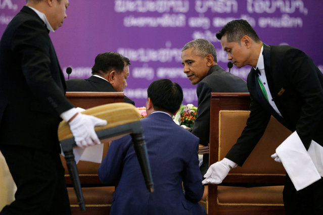 A translator helps Laos President Bounnhang Vorachith (seated, L) converse with U.S. President Barack Obama (seated, R) at a luncheon following their bilateral meeting, alongside the ASEAN Summit, at the Presidential Palace in Vientiane, Laos September 6, 2016. (Photo by Jonathan Ernst/Reuters)