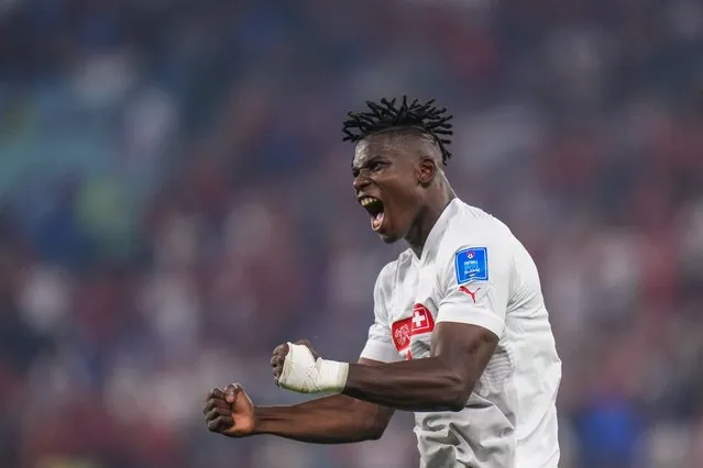 Switzerland's Breel Embolo celebrates after his teammate Switzerland's Remo Freuler scored his side's third goal during the World Cup group G soccer match between Serbia and Switzerland, at the Stadium 974 in Doha, Qatar, Friday, December 2, 2022. (Photo by Petr David Josek/AP Photo)