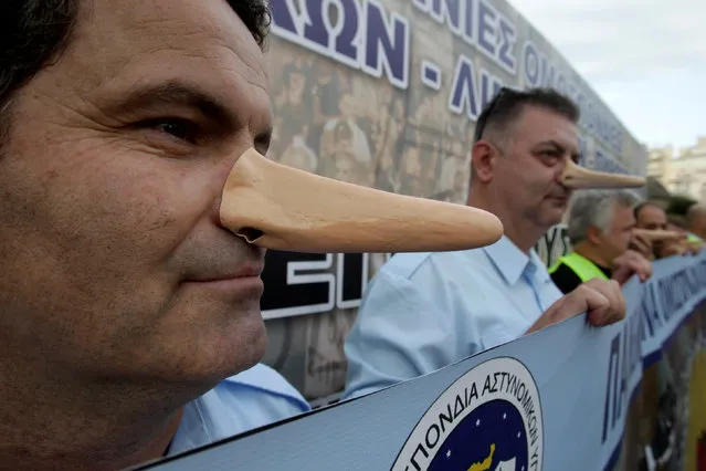 Police officers wear fake long noses in an anti-austerity rally of uniformed staff of the public sector, a day before the opening of the annual International Trade Fair of Thessaloniki by Greek Prime Minister Alexis Tsipras, in Thessaloniki, Greece September 9, 2016. (Photo by Alexandros Avramidis/Reuters)