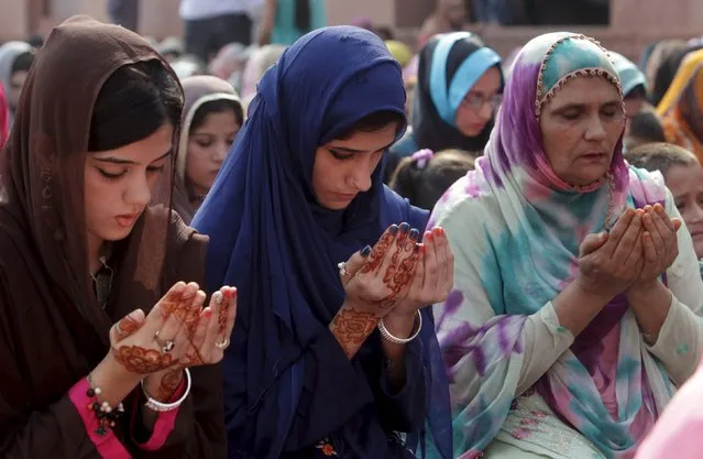 Muslim women perform their prayers at a mass prayer for Eid al-Adha at the Badshahi mosque in Lahore, Pakistan September 25, 2015. (Photo by Mohsin Raza/Reuters)