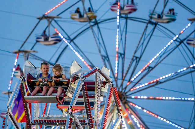 Young friends Elliott Clark and Gwen Pfeifer ride a mini Ferris wheel at the Good Neighbor Days festival in Washington, DC, on Friday, May 30, 2025. (Photo by Matt Dayhoff/Peoria Journal Star/USA Today Network)