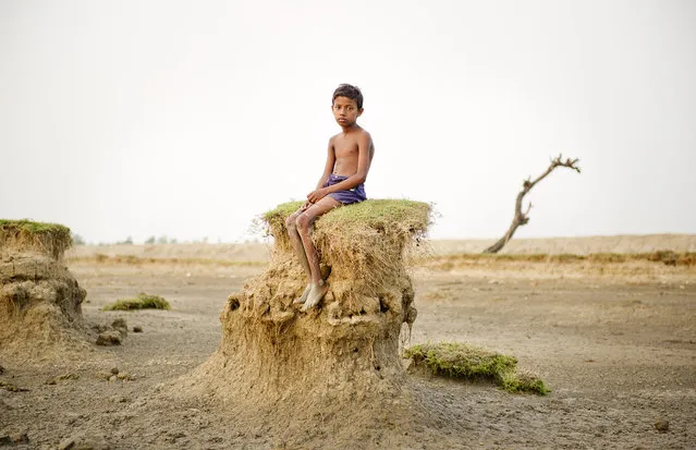 “Ghoramara island is located on a delta region in West Bengal. Due to the dramatic increase in sea level, resulting from the effects global warming since the 1960s, the shores of this island are being perpetually washed away. Since the 1980s more than 50% of the territory has vanished due to erosion by the sea. Many of the people still living on the island are farmers and fishermen who depend on the island's resources for their livelihoods. According to a civil servant I met, in 20-25 years the Indian government could abolish the island and has already formulated a plan to evacuate villagers to another island named Sagar. However, this evacuation plan does not ensure any financial support or compensation for those having to relocate their lives. I situated villagers on the shore and took portraits of them in juxtaposition with the beauty of the vanishing island. There will come a day when these people will have no choice but to move out of their homeland”. (Photo and comment by Daesung Lee, Korea/2013 Sony World Photography Awards