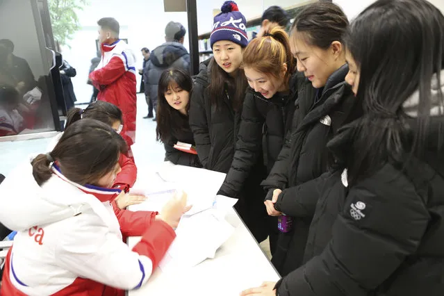 In this Thursday, January 25, 2018 photo provided by South Korea Unification Ministry on Friday, Jan. 26, 2018, South Korean women's hockey team players, right, talk with North Korean women's ice hockey team players, left, at the South Korea's national training center in Jincheon, South Korea. Female hockey players from the rival Koreas were paired up with each other Thursday to form their first-ever Olympic squad during next month's Pyeongchang Winter Games, as their countries press ahead with rare reconciliation steps following a period of nuclear tensions. (Photo by South Korea Unification Ministry via AP Photo)