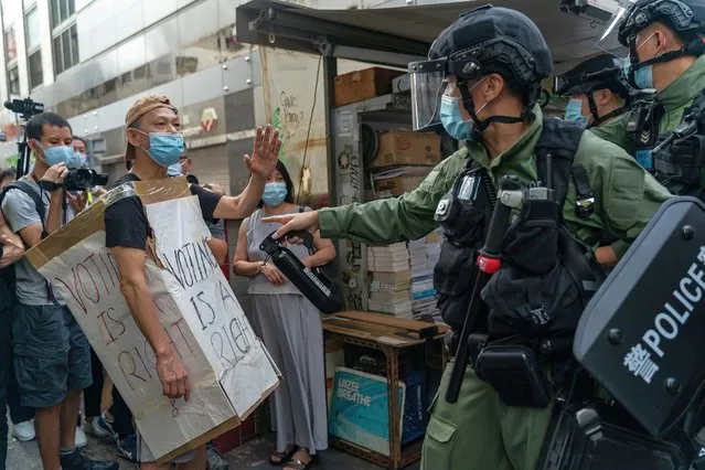 A man wearing a Voting Is A Right costome stand off with riot police during an anti-government protest on September 6, 2020 in Hong Kong, China. Nearly 300 people were arrested during the protest against the government's decision to postpone the legislative council election due to the Covid-19 and the newly imposed national security law. (Photo by Anthony Kwan/Getty Images)