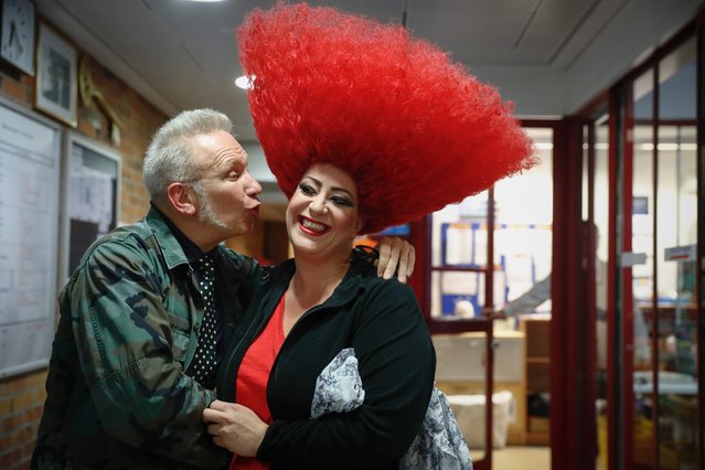 French fashion designer Jean Paul Gaultier (L)  pose with a performer from “The One” show back stage at the Friedrichstadt Palace in Berlin on September 22, 2016. Jean Paul Gaultier is the costume designer for the show opening in the German capital on October 16, 2016. (Photo by Odd Andersen/AFP Photo)
