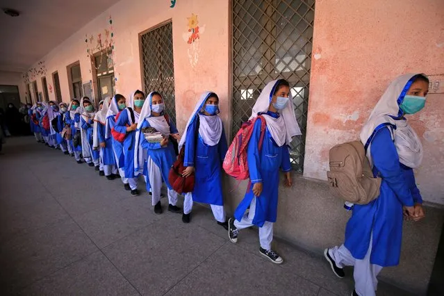 Students wearing face masks arrive to attend lectures on the first day of school after the resumption of classes of higher grades in Peshawar, Pakistan, 23 September 2020. The Pakistani government, on 23 September, reopened educational institutions to resume secondary classes as part of a phased reopening of schools. Pre-primary and primary classes are scheduled to resume on 30 September as cases of COVID-19 infections continue to decline in the country. (Photo by Bilawal Arbab/EPA/EFE)