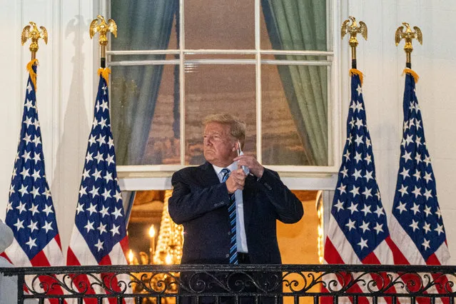 US President Donald J. Trump takes off his mask after returning to the White House, in Washington, DC, USA, 05 October 2020. Trump was returning to the White House following several days at Walter Reed National Military Medical Center for treatment for COVID-19. (Photo by Ken Cedeno/EPA/EFE)