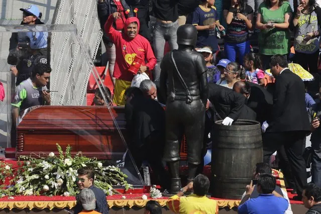 Pallbearers pull the coffin with the remains of the late screenwriter Roberto Gomez Bolanos as they arrive for a mass held in his honour at the Azteca stadium in Mexico City November 30, 2014. (Photo by Tomas Bravo/Reuters)