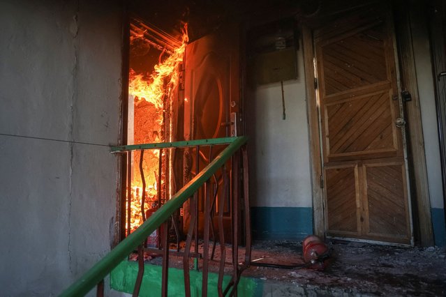 Fire burns in a flat of an apartment building hit by Russian drone strike, amid Russia's attack on Ukraine, in the town of Bilozerske in Donetsk region, Ukraine on August 10, 2025. (Photo by Oleksandr Ratushniak/Reuters)
