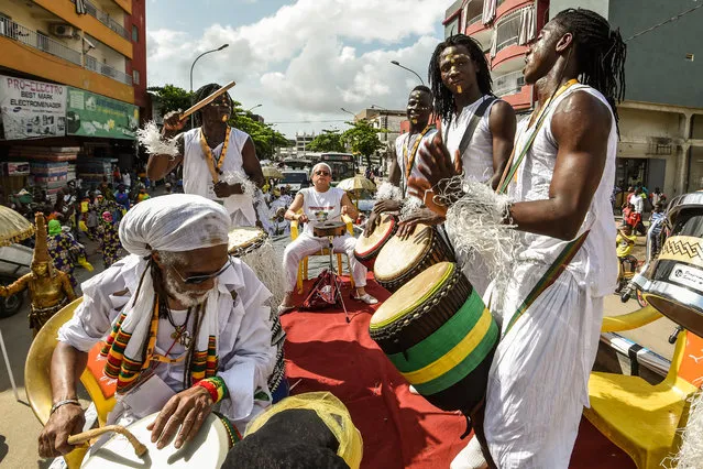 Members of the Afro-American group Jouvay Fest dance and play music in a parade during the start of MASA (African Performing Arts Market) in Abidjan on March 10, 2018. Created in 1993 under the impetus of the International Organization of the Francophonie (OIF), the biennial MASA (African Performing Arts Market) aims to facilitate access for African artists to the international market, runs from March 10 until March 17. (Photo by Sia Kambou/AFP Photo)