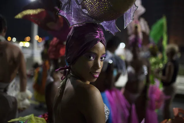 A reveler smiles before performing at a carnival parade in Havana August 8, 2014. Picture taken August 8, 2014. (Photo by Alexandre Meneghini/Reuters)