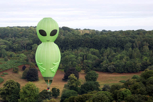 An alien-shaped hot air balloon flies during a mass launch at the annual Bristol International Balloon Fiesta, near Bristol, Britain, on August 8, 2025. (Photo by Toby Melville/Reuters)
