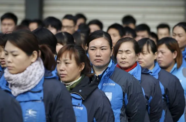 Workers listen to their line manager as he prepares them for the upcoming Singles Day shopping festival, at a sorting centre of Zhongtong (ZTO) Express, Chaoyang District, Beijing, November 8, 2015. (Photo by Jason Lee/Reuters)