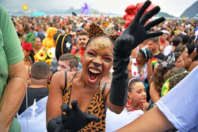 A reveller gestures during the Amigos da Onca street party in Rio de Janeiro, Brazil, on February 22, 2020, ahead of Rio's annual world famous carnival. Rio's 13 top samba schools will compete during two nights of flesh-flaunting, sequin-studded spectacle on the nights of February 23 and 24 to be this year's champions. (Photo by Carl De Souza/AFP Photo)