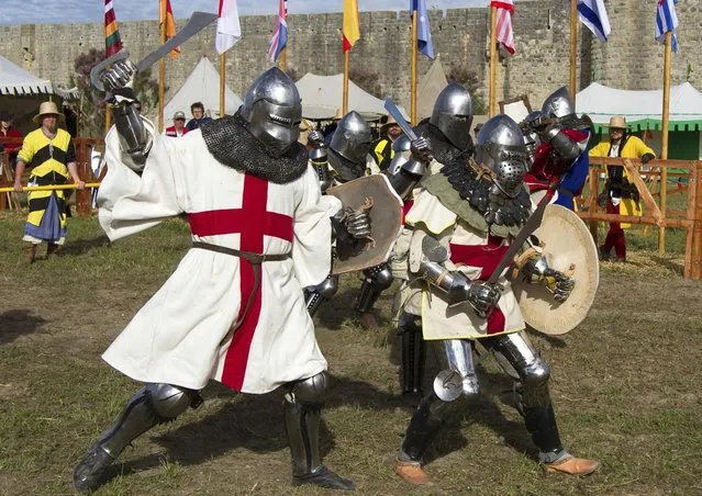 Members of UK team fight during the “Battle of Nations” in Aigues-Mortes, southern France, Friday, May 10, 2013 where Middle Ages fans attend the historical medieval battle competition. The championship will be attended by 22 national teams, which is twice the number it was last year. The battle lasts until May 12.(Photo by Philippe Farjon/AP Photo)