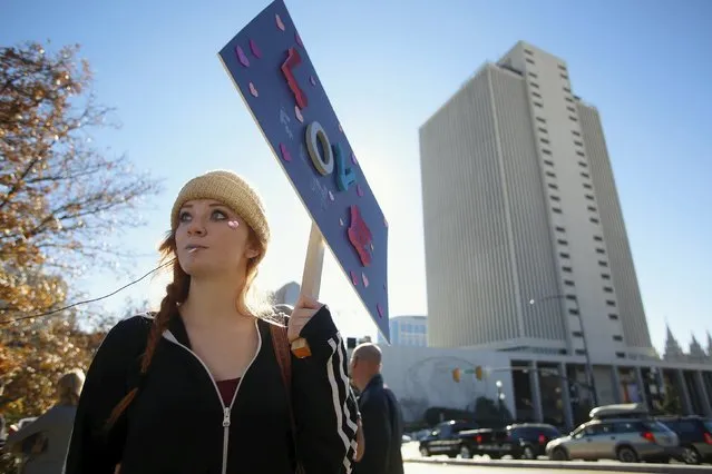 Member of The Church of Jesus Christ of Latter-day Saints Sarah Isaacson holds a sign as she resigns her membership to the church in Salt Lake City, Utah November 14, 2015. Hundreds of Mormons are expected to mail letters resigning from the faith after gathering in Salt Lake City on Saturday to protest a new church policy that calls married same-s*x couples apostates and bars their children from baptism. (Photo by Jim Urquhart/Reuters)