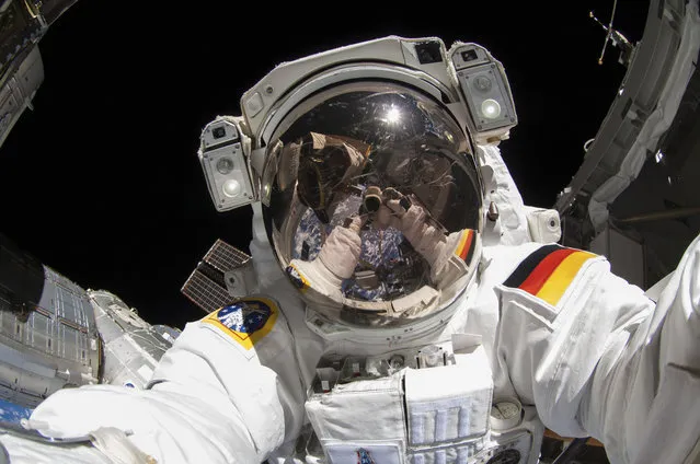 European Space Agency astronaut taking a photograph of his visor during extravehicular activity (EVA) on the International Space Station (ISS) on October 10, 2014. (Photo by NASA/SPL/Barcroft Media)