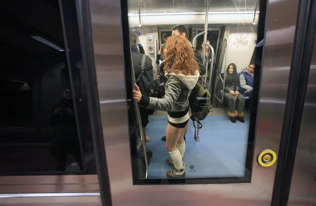 A passenger without pants stands inside a subway train during “The No Pants Subway Ride” in Bucharest January 11, 2015. (Photo by Radu Sigheti/Reuters)
