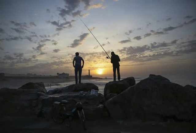 Fishermen wait for a catch on Rabat beach, Morocco, on Wednesday, November 2, 2016. Rabat beach is a hub for families, couples and fitness enthusiasts especially on temperate days. (Photo by Mosa'ab Elshamy/AP Photo)