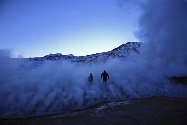 “Experiencing”. Silhouettes of father and his son walking through the steam coming for Geysers el Tatio in North Chile. (Photo and caption by Magdalena Rakita/National Geographic Traveler Photo Contest)