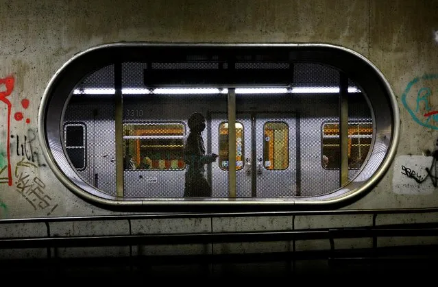 A woman wearing a protective mask walks along an underground platform during the second lockdown as the coronavirus disease continues in Vienna, Austria, November 12, 2020. (Photo by Lisi Niesner/Reuters)
