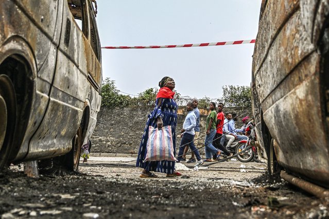 Residents walk by charred vehicles in Goma, Democratic republic of the Congo, Friday, January 31, 2025. (Photo by Moses Sawasawa/AP Photo)