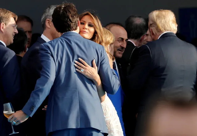U.S. first lady Melania Trump kisses Canada's Prime Minister Justin Trudeau as they arrive at the park of the Cinquantenaire, during a NATO Summit, in central Brussels, Belgium July 11, 2018. (Photo by Yves Herman/Reuters)